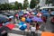 Hanoi, Vietnam - Aug 24, 2017: Busy street with crowded people using umbrella in rainy morning on a street in Times City, Minh Kha