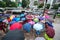 Hanoi, Vietnam - Aug 24, 2017: Busy street with crowded people using umbrella in rainy morning on a street in Times City, Minh Kha