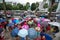 Hanoi, Vietnam - Aug 24, 2017: Busy street with crowded people using umbrella in rainy morning on a street in Times City, Minh Kha