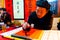 HANOI, VIETNAM, FEB 14, 2018: Old master is writing ancient letter for everyone in lunar new year in Hanoi, Vietnam. This is a
