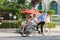 Hanoi, Vietnam - Feb 27, 2020: Hanoi old quarter main square, rickshaw drivers carrying tourists around town.