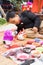 Hanoi, Vietnam - Feb 7, 2015: Schoolboy learn to paint plaster figurine by brush and color ink at Vietnamese lunar new year festiv