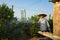 Hanoi, Vietnam - Jan 10, 2016: Farmer waters Kumquat in Nhat Tan garden, one month before Vietnamese lunar new year Tet. Kumquat t