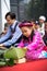 Hanoi, Vietnam - Jan 14, 2017: Little girl wear traditional dress Ao Dai learning to make Chung cake by hands at an even at Elemen