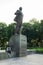 Hanoi, Vietnam - July 10, 2016: Vladimir Ilyich Lenin statue, with a student reading book by the statue, in Lenin park, Dien Bien