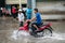 Hanoi, Vietnam - July 17, 2017: A motorcyclist rides along flooded Minh Khai street in Hanoi city, Vietnam