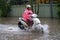 Hanoi, Vietnam - July 17, 2017: A motorcyclist rides along flooded Minh Khai street in Hanoi city, Vietnam