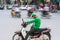 Hanoi, Vietnam - July 7, 2017: Grab motorbike driver waiting for customer on Ba Trieu street. Entered Vietnam in 2014, Grab growin