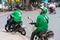 Hanoi, Vietnam - July 7, 2017: Grab motorbike driver waiting for customer on Ba Trieu street. Entered Vietnam in 2014, Grab growin