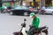 Hanoi, Vietnam - July 7, 2017: Grab motorbike driver waiting for customer on Ba Trieu street. Entered Vietnam in 2014, Grab growin