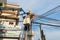 Hanoi, Vietnam - June 14, 2015: Workers repair telecommunication cable after heavy wind storm in Truong Dinh street