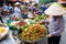 HANOI, VIETNAM - MAY 22, 2017: Woman selling tropical fruit on a