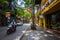 Hanoi, Vietnam - May 28, 2023: Enchanting Old town streets reveal a vibrant tableau: motorcycles and bicycles whizzing by,