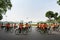 Hanoi, Vietnam - Oct 16, 2016: Vietnamese girls wear traditional long dress Ao Dai cycling on Hanoi street. Hochiminh mausoleum sq