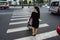 Hanoi, Vietnam - Oct 19, 2016: Mother with a baby stroller crossing the street in Minh Khai. Vehicles running on street.