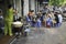 Hanoi, Vietnam - Sep 2, 2015: People eating Vietnamese traditional noodle soup Pho on sidewalk. Eating on pavement is common in Ha