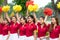 Hanoi, Vietnam - Sep 2, 2016: Young cheerleader group cheering with pom poms in hands