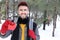 Hansome man holding Christmas present in the snow