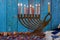 Hanukkah celebration with menorah with wooden dreidels and candles