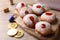 Hanukkah donuts, dreidels and coins on wooden table