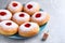 Hanukkah doughnuts with jelly and dreidel on grey table
