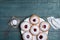 Hanukkah doughnuts with jelly and sugar powder served on blue wooden table, flat lay