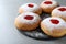 Hanukkah doughnuts with jelly and sugar powder served on grey table, closeup
