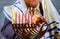 Hanukkah, a Jewish celebration. Candles burning in the menorah, man in the background.