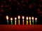 Hanukkah is a Jewish religious holiday of candles. Nine burning candles on dark background. The Feast of Fire and Light