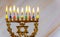 Hanukkah menorah with burning colored candles. Close up