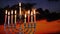 Hanukkah menorah with candles, sunset sky background