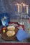 Hanukkah Menorah with lit Candles, Gifts, Dreidel and Jelly Fill