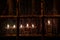 Hanukkah menorah in a window wet with raindrops