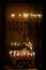 Hanukkah menorahs burning both oil and wax candles
