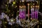 Hanukkah symbol depicting a lit Hanukkiah Menorah with lit candles on a blurred background of blurred bokeh on a Jewish