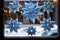 hanukkah-themed paper snowflakes glued onto a window