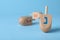 Hanukkah traditional dreidel with letter Nun on light blue background, space for text