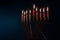 Hanukkiah Menorah with candles burning is a traditional symbol of Jewish faith during holiday Hanukkah