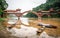 Haoshang arch bridge in oriental Buddha park and small fishing boats on the river in Leshan China