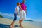 The happiest childhood: father and son walking along the tropical beach