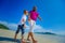 The happiest childhood: father and son walking along the tropical beach