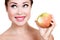 Happily smiling woman with a ripe apple