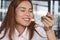 Happiness Asian woman eating a peace of coconut cream cake