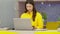 Happiness Attractive Asian woman in yellow shirt working with computer laptop thinking to get ideas and requirement in Business