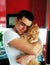 Happiness. Cat with Young Man. Orange Persian Cat. Lover Man, Hugging and Cuddling his Happy Domestic Cat Pet. Love to the animals