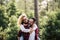 Happiness and cheerful people concpet with joyful couple playing and having fun together in the wood country side - adult man and