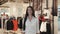 Happiness, consumerism, sale and people concept - smiling young woman with shopping bags over mall background student