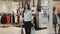 Happiness, consumerism, sale and people concept - smiling young woman with shopping bags over mall background student