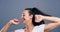 Happiness, dance and face of woman in studio isolated on a gray background. Dancing, smile and female person moving