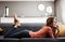 Happiness is a day spent unwinding. an attractive young woman relaxing on the sofa at home.